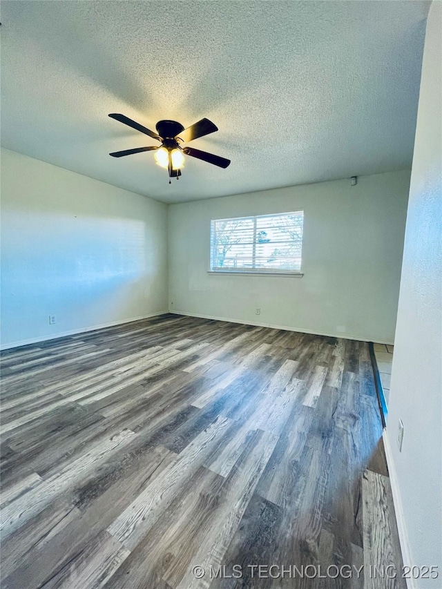 unfurnished room with ceiling fan, baseboards, a textured ceiling, and wood finished floors