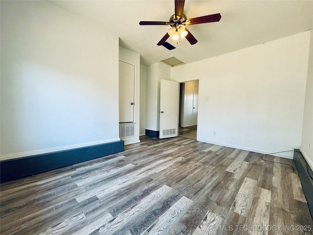 unfurnished room featuring visible vents, baseboards, a ceiling fan, and wood finished floors