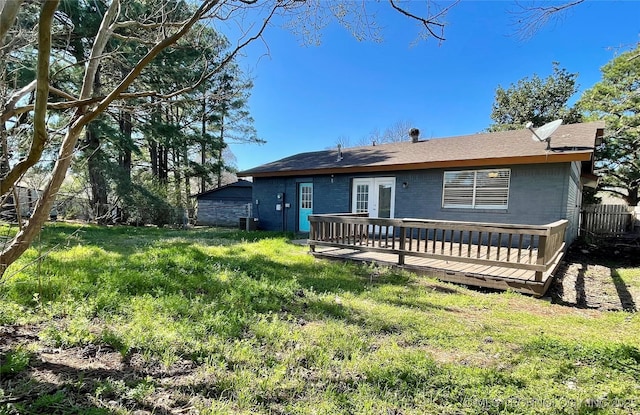 back of house with a wooden deck, a yard, central AC unit, and fence