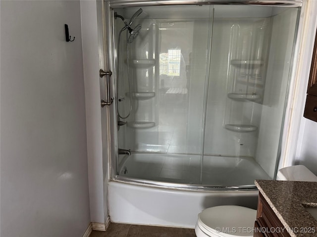 full bath featuring toilet, vanity, and bath / shower combo with glass door