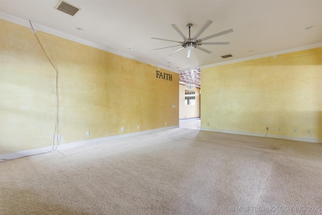 carpeted empty room featuring visible vents, ceiling fan, and ornamental molding