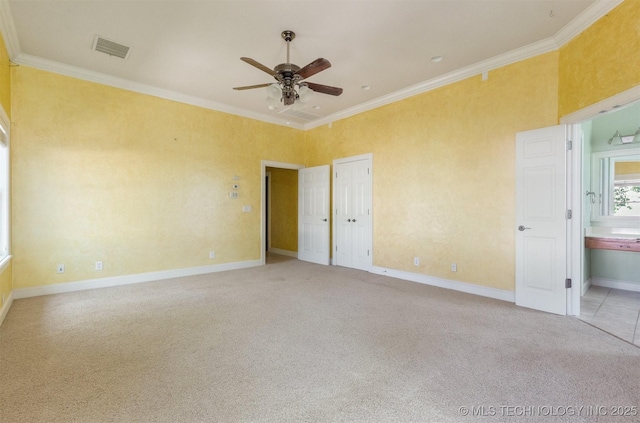 unfurnished bedroom with visible vents, crown molding, baseboards, and carpet floors