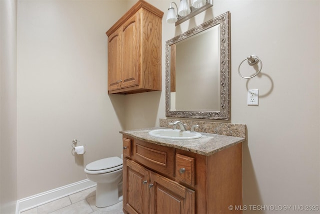 half bathroom featuring tile patterned floors, baseboards, toilet, and vanity