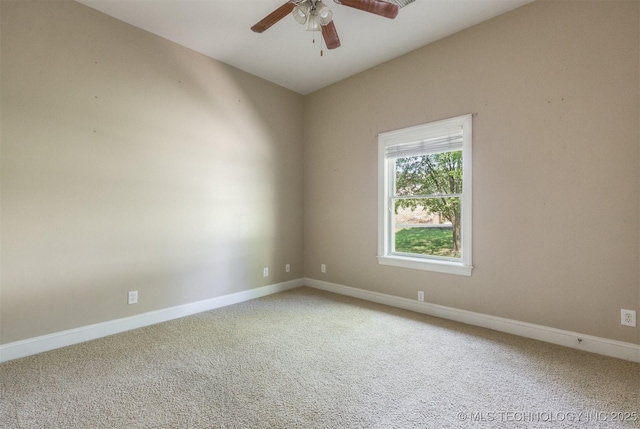 carpeted spare room with baseboards and ceiling fan