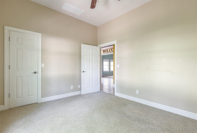 unfurnished room featuring baseboards, a ceiling fan, and carpet