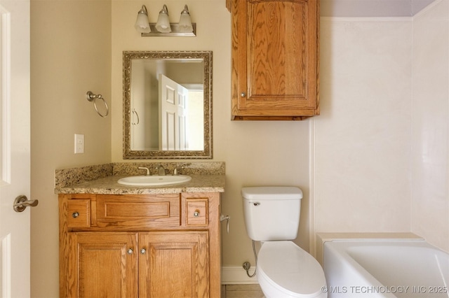 bathroom with vanity, toilet, and a bathtub