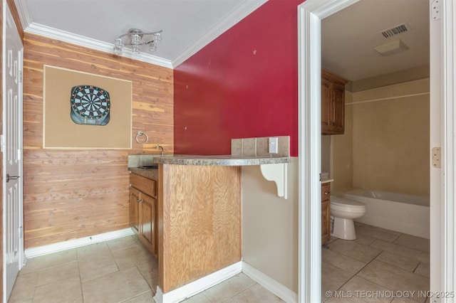 full bathroom with visible vents, toilet, ornamental molding, wooden walls, and tile patterned flooring