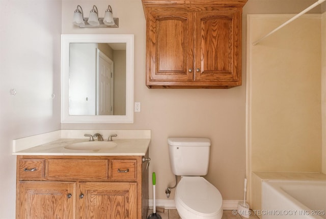 full bathroom with toilet, a bath, vanity, and baseboards