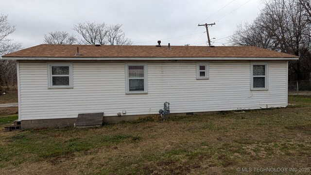 back of property with a yard and crawl space