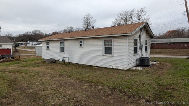 back of house featuring a yard, cooling unit, and fence