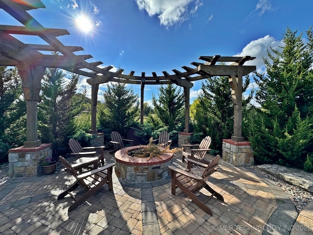 view of patio / terrace with a fire pit and a pergola