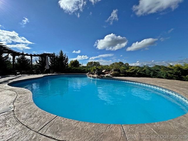 pool featuring a pergola and a patio