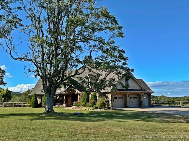 craftsman-style house with a garage, driveway, a front yard, and fence