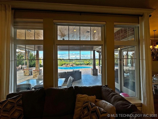 doorway to outside featuring a chandelier