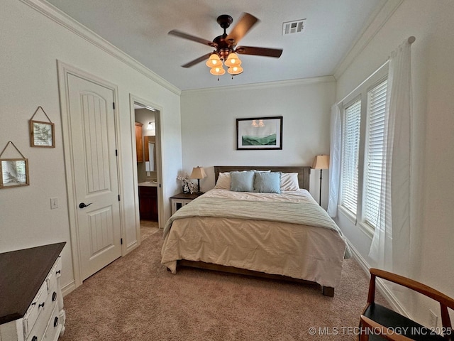 bedroom with a ceiling fan, visible vents, light carpet, crown molding, and connected bathroom