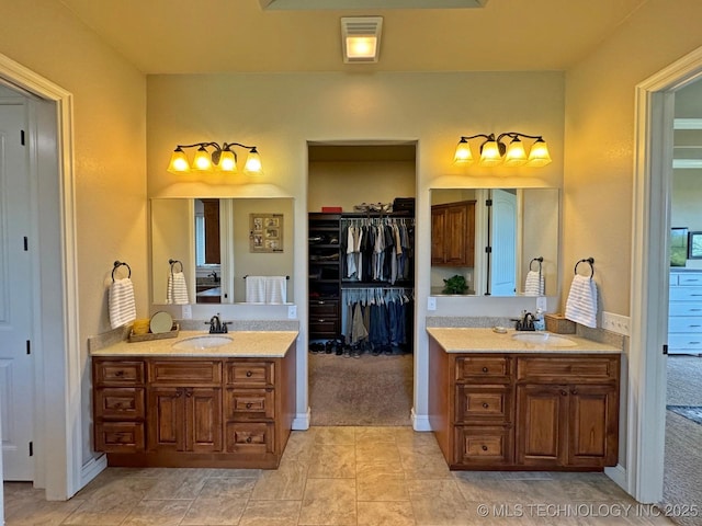 full bathroom featuring a sink, visible vents, and two vanities