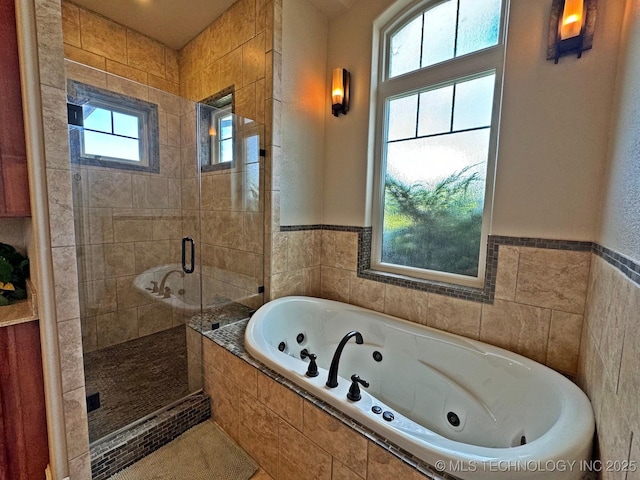 bathroom featuring a jetted tub and a stall shower