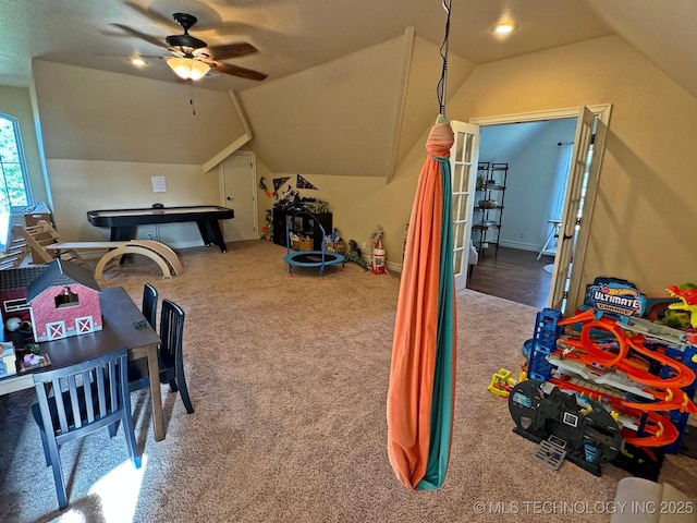 playroom with lofted ceiling, carpet flooring, and a ceiling fan