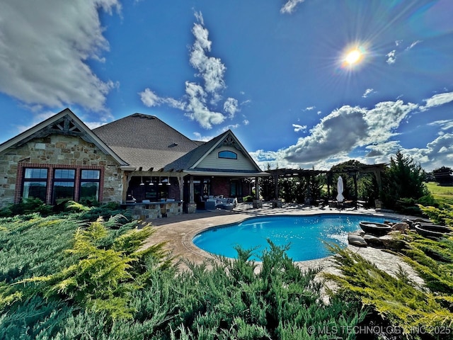 outdoor pool with a patio and a pergola