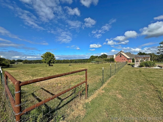 view of yard featuring a rural view and fence