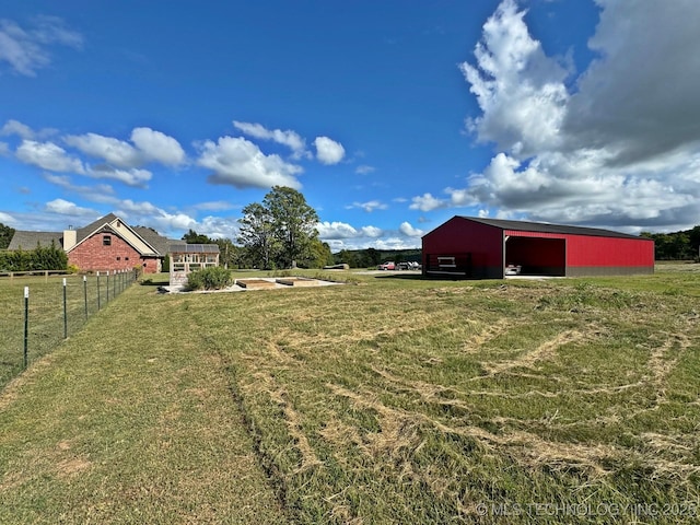 view of yard with an outbuilding, fence, and a garage