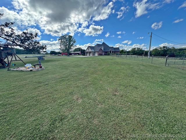 view of yard with playground community and fence