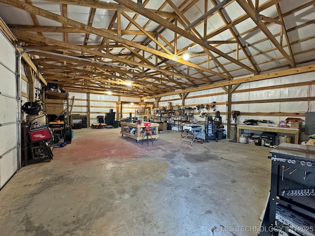 garage featuring a workshop area and metal wall