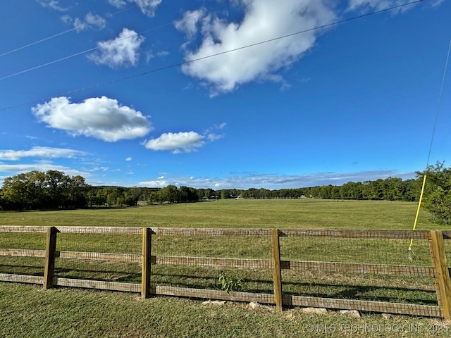 view of yard featuring a rural view and fence