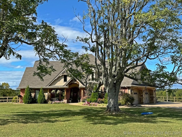 view of front of property featuring a front lawn, fence, and roof with shingles