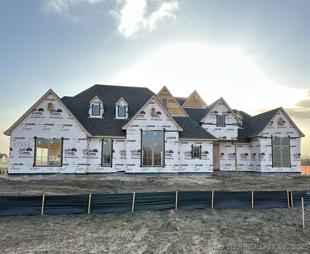 property under construction with roof with shingles