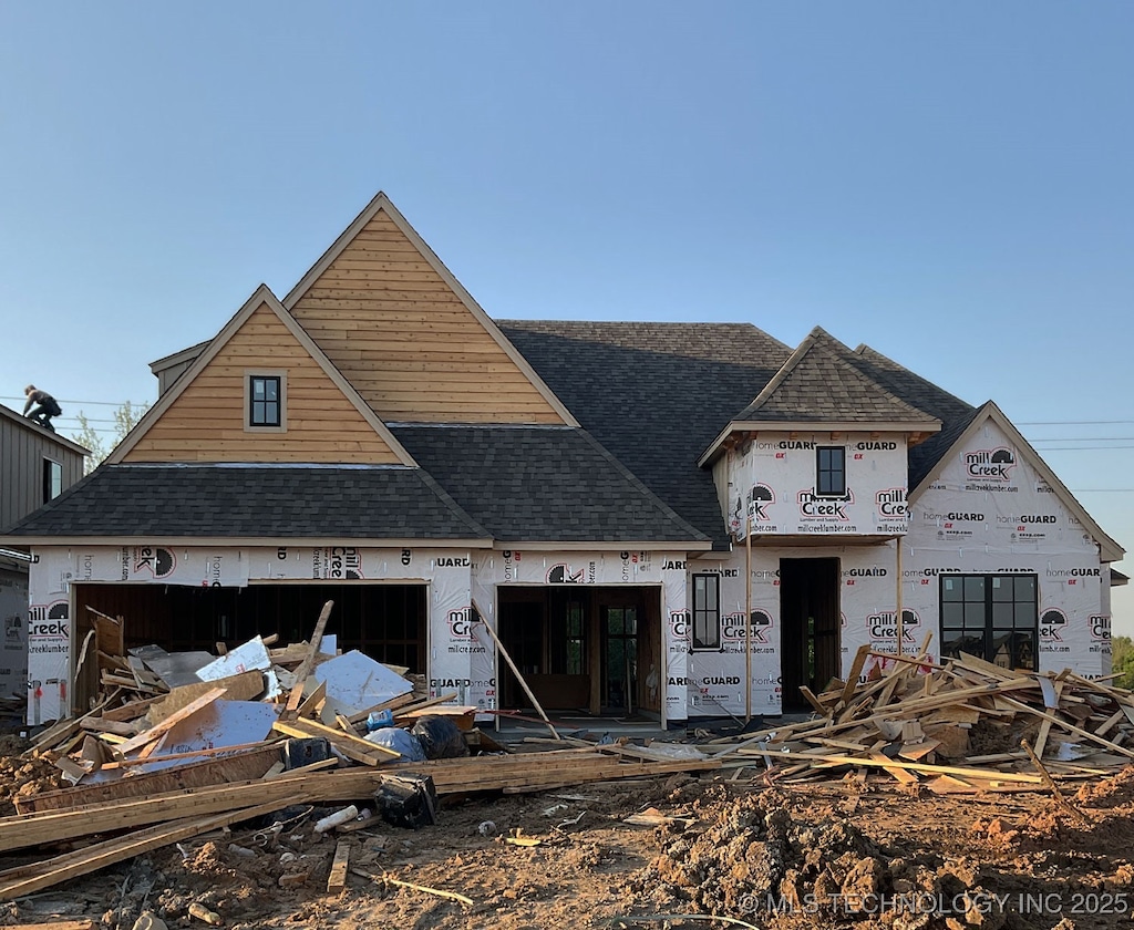 property under construction with a shingled roof
