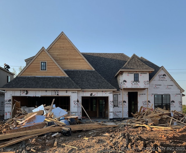 property under construction with a shingled roof