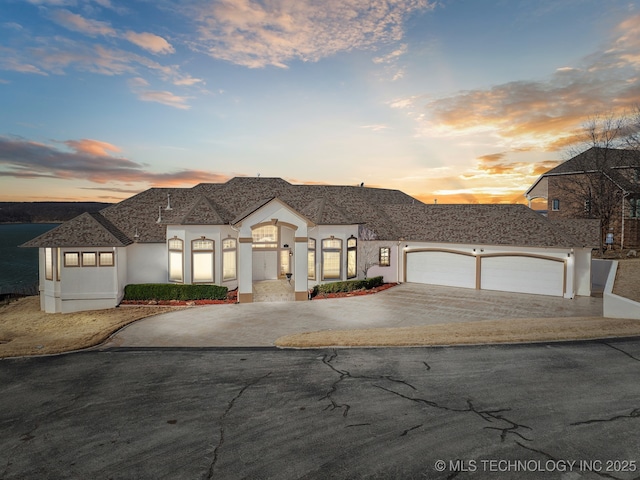 view of front of property featuring stucco siding, a garage, and concrete driveway