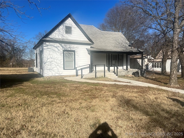 view of front of property with central AC unit, a porch, and a front yard