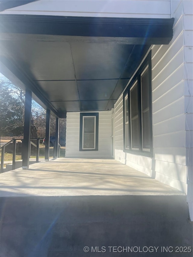 view of patio / terrace featuring covered porch and an attached carport