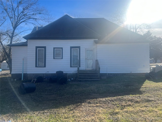 view of front of property with a shingled roof and entry steps