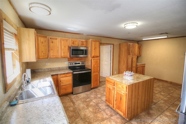 136 Pine St, Mead, OK 73449 - kitchen featuring visible vents, a kitchen island, light countertops, stainless steel appliances, and a sink