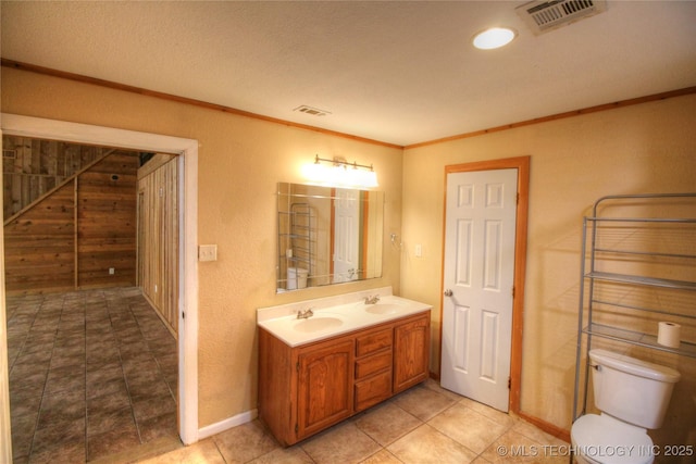 136 Pine St, Mead, OK 73449 - full bathroom with toilet, ornamental molding, visible vents, and a sink