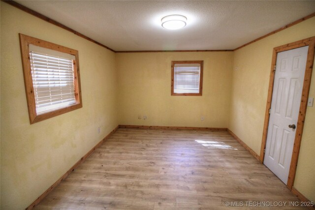 136 Pine St, Mead, OK 73449 - unfurnished bedroom featuring crown molding, baseboards, and light wood-type flooring