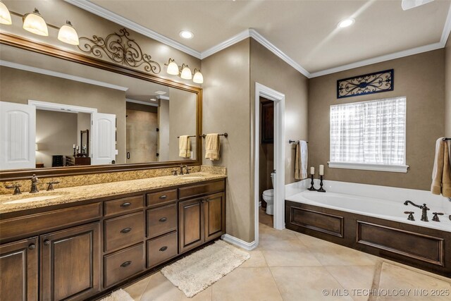bathroom with double vanity, toilet, a bath, and a sink