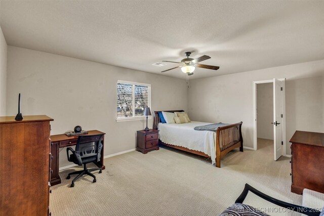 bedroom featuring baseboards, ceiling fan, light carpet, and visible vents