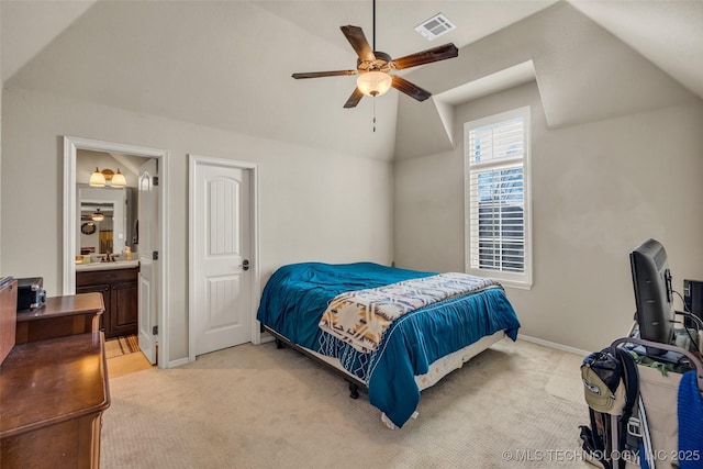 bedroom featuring ensuite bathroom, visible vents, baseboards, light colored carpet, and lofted ceiling