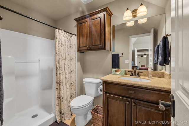 bathroom featuring vanity, toilet, and a shower stall