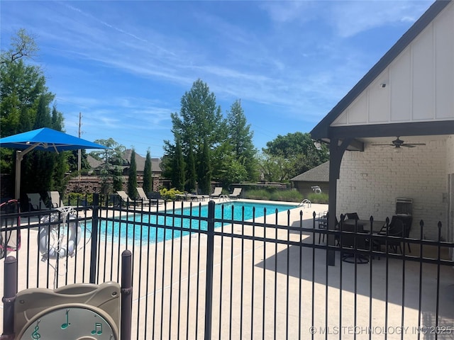 community pool featuring a patio area, a ceiling fan, and fence