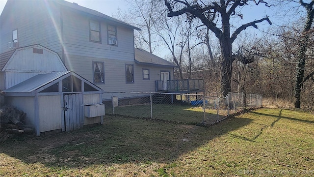 305 E 48th Pl, Sand Springs, OK 74063 - back of house featuring an outbuilding, fence, and a lawn