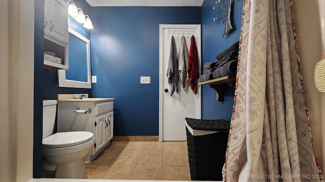 305 E 48th Pl, Sand Springs, OK 74063 - bathroom featuring toilet, vanity, baseboards, and tile patterned flooring
