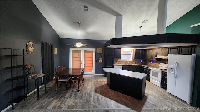 305 E 48th Pl, Sand Springs, OK 74063 - kitchen with visible vents, a center island, light countertops, white appliances, and under cabinet range hood