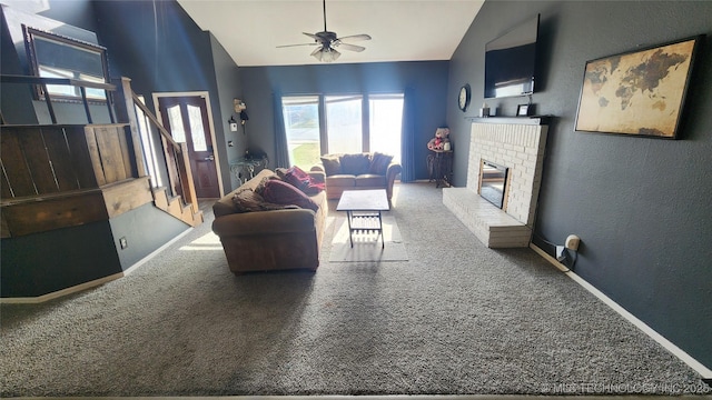 305 E 48th Pl, Sand Springs, OK 74063 - living area with vaulted ceiling, a textured wall, carpet flooring, a brick fireplace, and ceiling fan