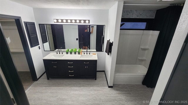 305 E 48th Pl, Sand Springs, OK 74063 - bathroom featuring a sink, bathtub / shower combination, and double vanity