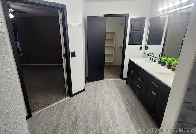 305 E 48th Pl, Sand Springs, OK 74063 - full bathroom featuring a ceiling fan, a spacious closet, wood finished floors, a sink, and double vanity
